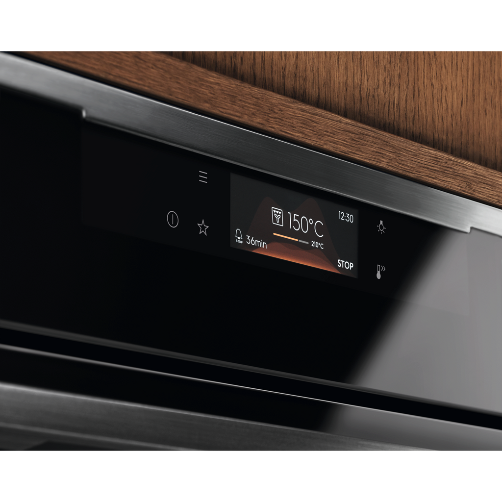 Electrolux KOFBC38H 60 cm 500 SurroundCook built-in single oven, 72 L, angled close-up of the lit display in a timber kitchen cabinet
