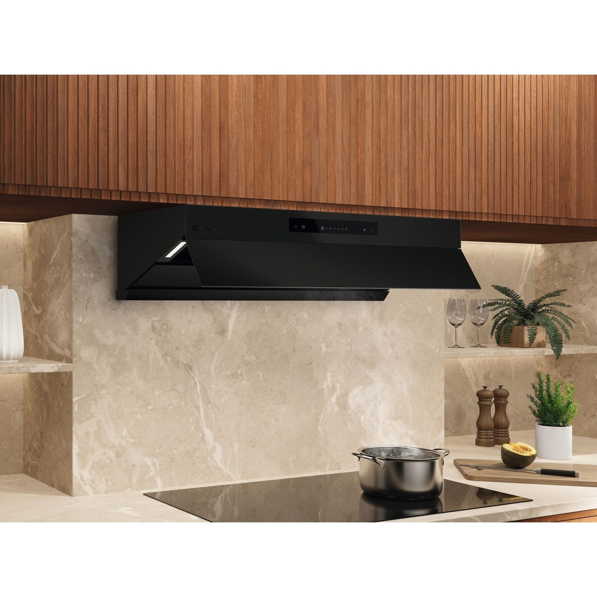 Electrolux ECC9945KB 90 cm slant extractor hood in black glass mounted under timber cabinetry above an induction hob