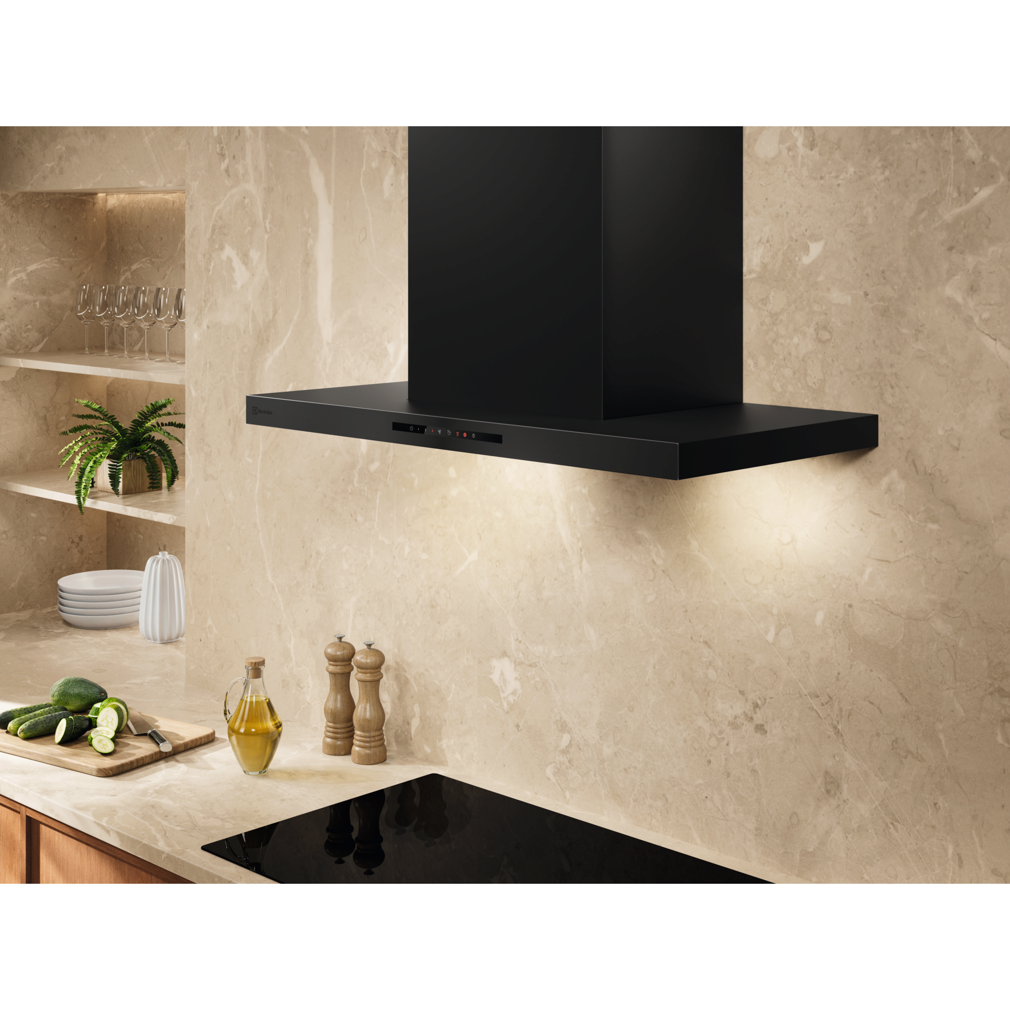 Electrolux ECT9633KB 90 cm 600 Series chimney extractor hood installed above a black hob against a marble splashback, lights on
