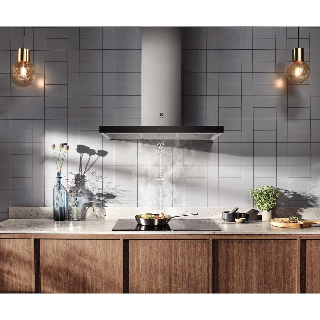Electrolux ECT9744H 90 cm chimney extractor hood installed over an induction hob against a grey tiled splashback