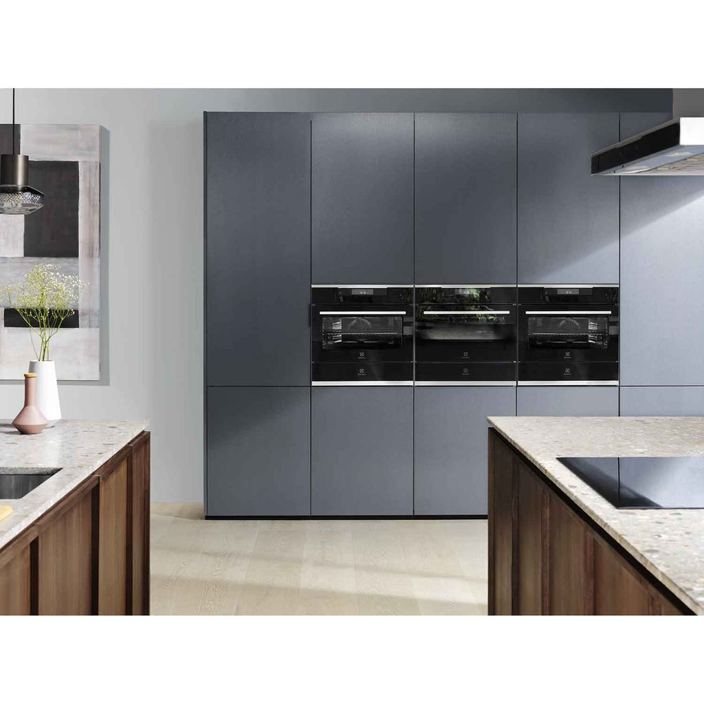 Electrolux KBD4X 60 cm UltimateTaste 700 built-in warming drawer in a column of black Electrolux built-in appliances set into grey kitchen cabinetry