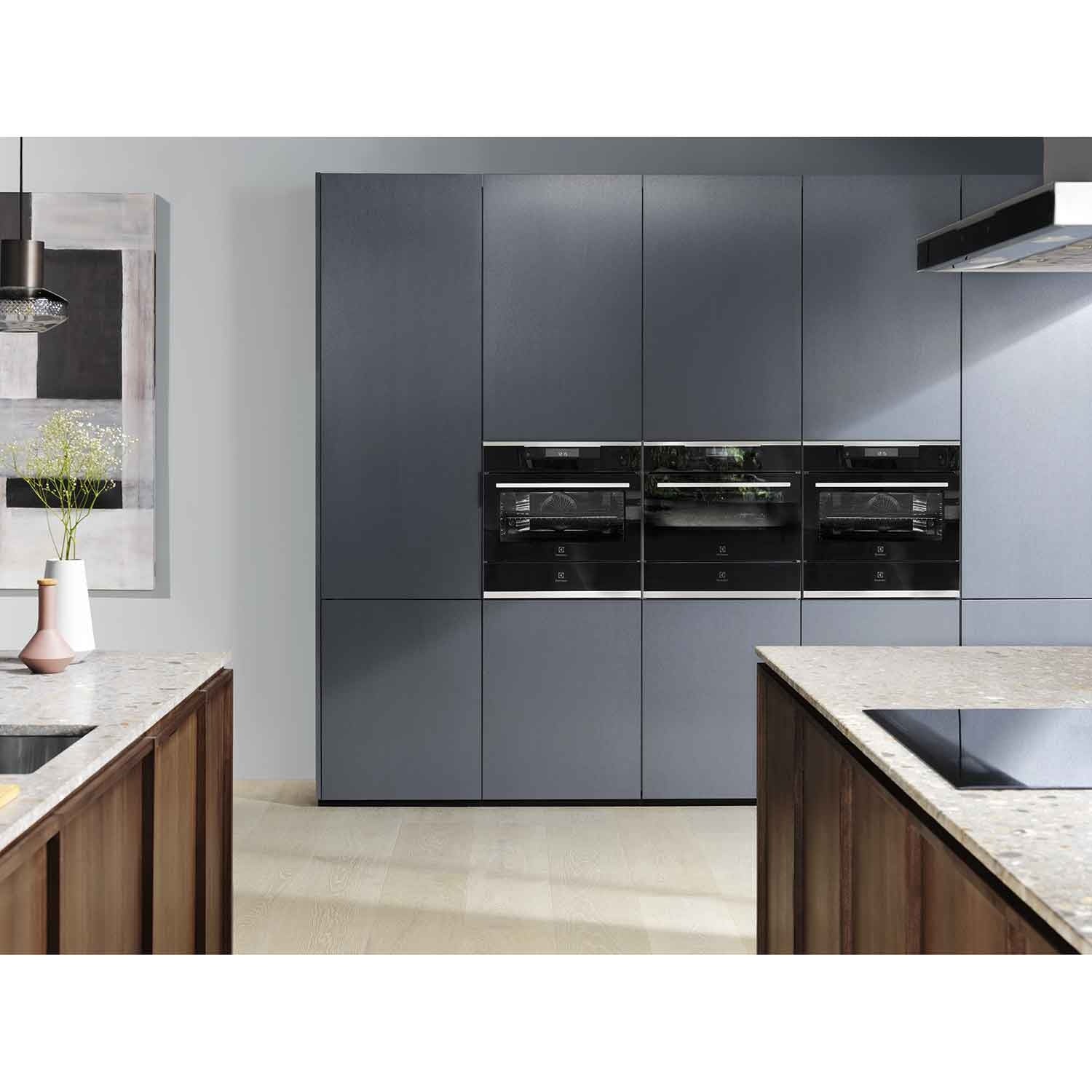 Electrolux KBD4X 60 cm UltimateTaste 700 built-in warming drawer in a column of black Electrolux built-in appliances set into grey kitchen cabinetry