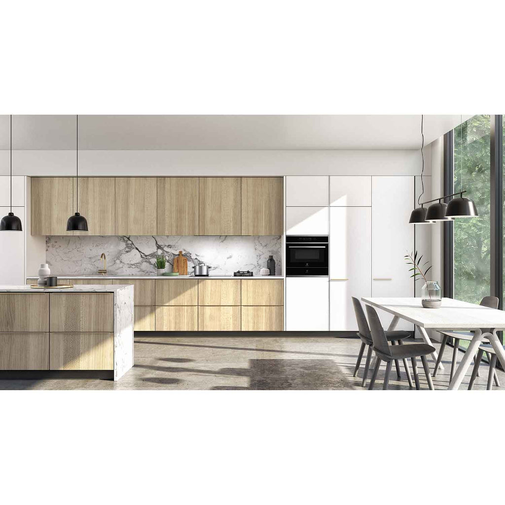 Electrolux KBD4X 60 cm UltimateTaste 700 built-in warming drawer, kitchen setting with a black Electrolux built-in appliance column in light timber and white cabinetry