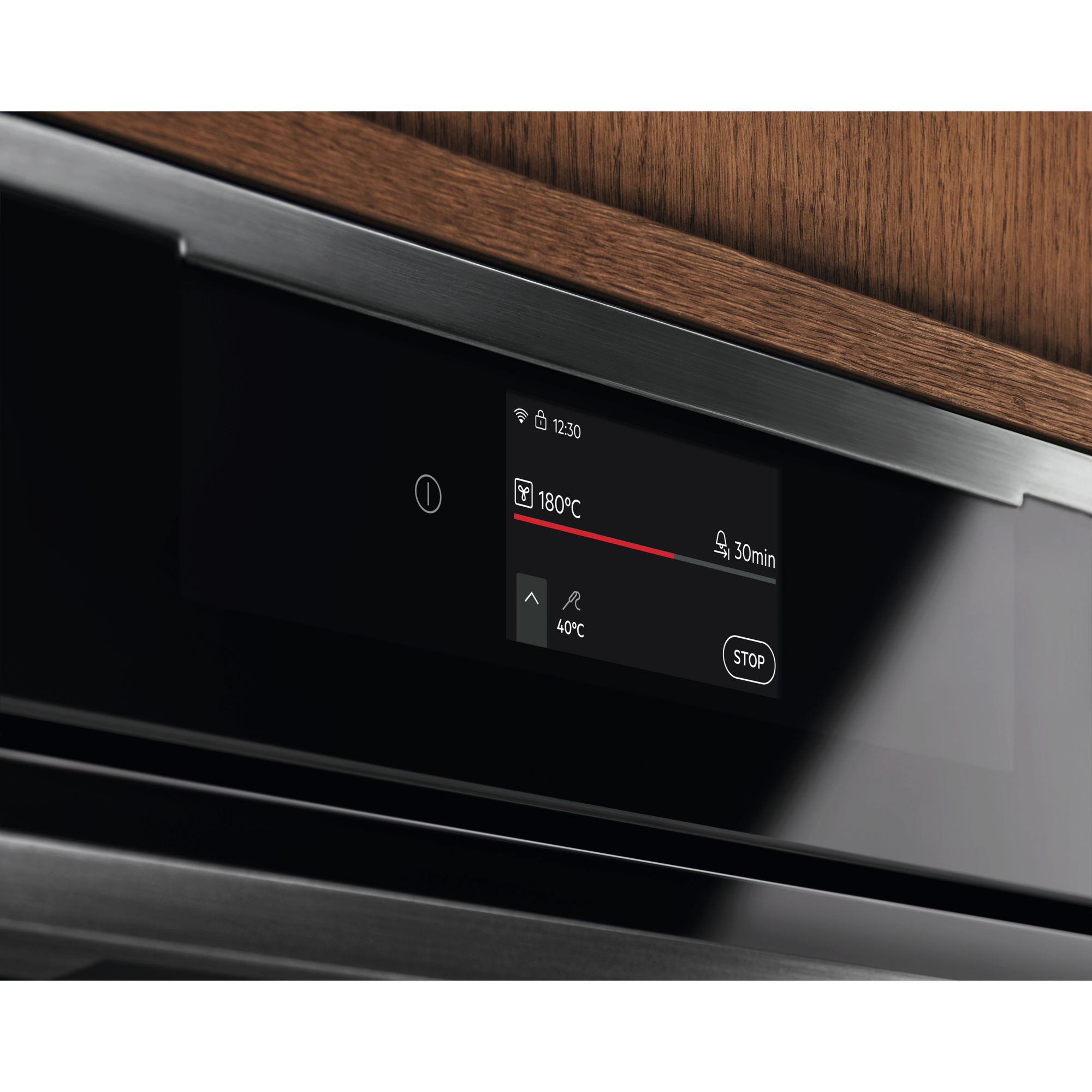 Electrolux KOCAP3XH 60 cm built-in steam oven, close-up of the touch display showing temperature and cooking time in a walnut kitchen